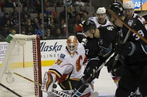 Nov 3, 2016; San Jose, CA, USA; Calgary Flames goalie Chad Johnson (31) makes a save against San Jose Sharks center Tommy Wingels (57) during the second period at SAP Center at San Jose. Mandatory Credit: Neville E. Guard-USA TODAY Sports