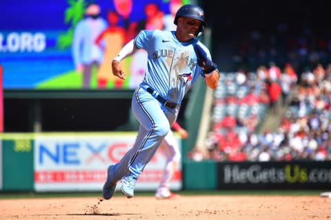 Apr 9, 2023; Anaheim, California, USA; Toronto Blue Jays right field Whit Merrifield (15) runs home to score against the Los Angeles Angels during the sixth inning at Angel Stadium. Mandatory Credit: Gary A. Vasquez-USA TODAY Sports