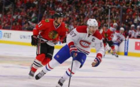 Nov 13, 2016; Chicago, IL, USA; Montreal Canadiens left wing Max Pacioretty (67) being pursued by Chicago Blackhawks left wing Andrew Desjardins (11) during the third period at the United Center. Chicago won 3-2. Mandatory Credit: Dennis Wierzbicki-USA TODAY Sports