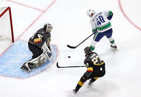 Elias Pettersson of the Vancouver Canucks attempts a shot on Robin Lehner (Photo by Bruce Bennett/Getty Images)