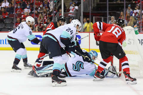 Kraken goaltender Joey Daccord and Devils center Dawson Mercer: (Ed Mulholland-USA TODAY Sports)