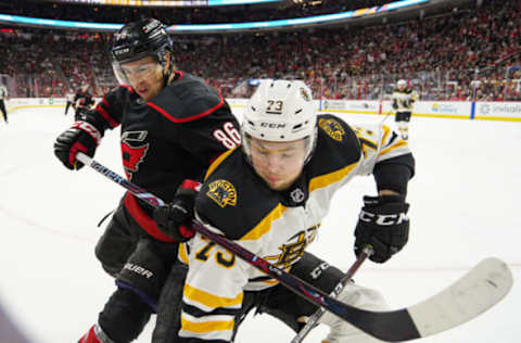 RALEIGH, NC – MAY 14: Carolina Hurricanes left wing Teuvo Teravainen (86) and Boston Bruins defenseman Charlie McAvoy (73) battle for a puck along the boards during a game between the Boston Bruins and the Carolina Hurricanes on May 14, 2019 at the PNC Arena in Raleigh, NC. (Photo by Greg Thompson/Icon Sportswire via Getty Images)