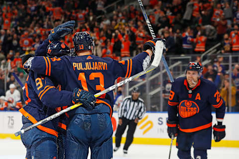 Feb 11, 2022; Edmonton, Alberta, CAN; The Edmonton Oilers celebrate a goal by forward Jesse Puljujarvi (13) against the New York Islanders during the third period at Rogers Place. Mandatory Credit: Perry Nelson-USA TODAY Sports