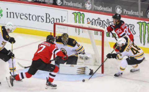 Jan 16, 2021; Newark, New Jersey, USA; New Jersey Devils left wing Yegor Sharangovich (17) and Boston Bruins defenseman Matt Grzelcyk (48) look for the puck after a save by Boston Bruins goaltender Jaroslav Halak (41) during the second period at Prudential Center. Mandatory Credit: Ed Mulholland-USA TODAY Sports