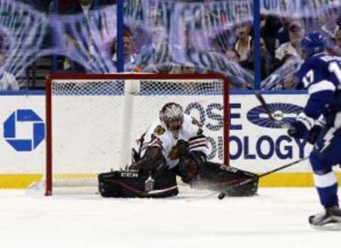 Jan 21, 2016; Tampa, FL, USA; Chicago Blackhawks goalie Corey Crawford (50) makes a save against the Tampa Bay Lightning during the third period at Amalie Arena. Tampa Bay Lightning defeated the Chicago Blackhawks 2-1. Mandatory Credit: Kim Klement-USA TODAY Sports