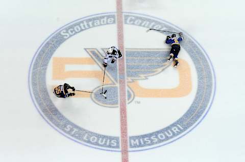 Apr 19, 2017; St. Louis, MO, USA; St. Louis Blues defenseman Colton Parayko (55) and Minnesota Wild left wing Zach Parise (11) battle for the puck as defenseman Joel Edmundson (6) falls to the ice during the third period in game four of the first round of the 2017 Stanley Cup Playoffs at Scottrade Center. The Wild won 2-0. Mandatory Credit: Jeff Curry-USA TODAY Sports