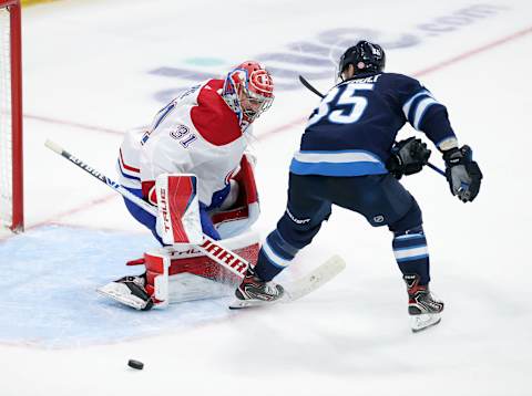 WINNIPEG, MANITOBA – JUNE 04: Carey Price #31 of the Montreal Canadiens makes a stop under pressure from Mathieu Perreault #85 of the Winnipeg Jets in Game Two of the Second Round of the 2021 Stanley Cup Playoffs on June 4, 2021 at Bell MTS Place in Winnipeg, Manitoba, Canada. (Photo by Jason Halstead/Getty Images)