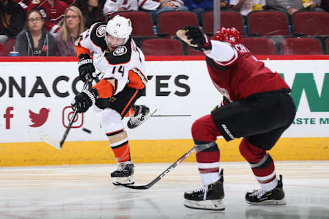 GLENDALE, ARIZONA – NOVEMBER 27: Adam Henrique #14 of the Anaheim Ducks shoots the puck past Jakob Chychrun #6 of the Arizona Coyotes (Photo by Christian Petersen/Getty Images)