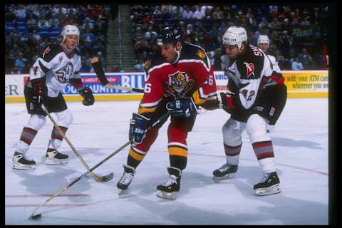 11 Nov 1996: Rightwinger Ray Sheppard of the Florida Panthers (center) works against Buffalo Sabres defensemen Richard Smehlik (right) and Jay McKee during a game at the Marine Midland Arena in Buffalo, New York. The Sabres won the game, 3-2. Mandatory