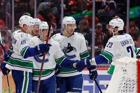 Jan 16, 2022; Washington, District of Columbia, USA; Vancouver Canucks center Elias Pettersson (40) celebrates with teammates after scoring a goal against the Washington Capitals during the second period at Capital One Arena. Mandatory Credit: Geoff Burke-USA TODAY Sports