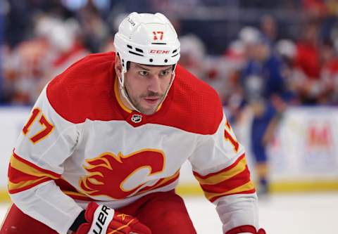 Nov 18, 2021; Buffalo, New York, USA; Calgary Flames left wing Milan Lucic (17) goes after a loose puck during the third period against the Buffalo Sabres at KeyBank Center. Mandatory Credit: Timothy T. Ludwig-USA TODAY Sports