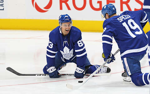 Cody Ceci #83 of the Toronto Maple Leafs chats with teammate Jason Spezza #19 during warm-up (Photo by Claus Andersen/Getty Images)