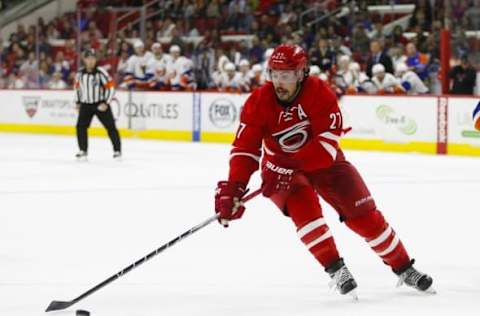 Mar 26, 2016; Raleigh, NC, USA; Carolina Hurricanes defensemen Justin Faulk (27) skates with the puck against the New York Islanders at PNC Arena. The New York Islanders defeated the Carolina Hurricanes 4-3 in the overtime. Mandatory Credit: James Guillory-USA TODAY Sports