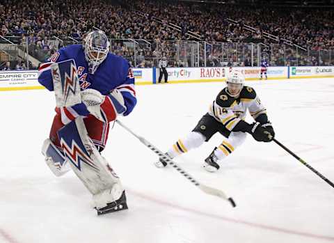 : Alexandar Georgiev #40 of the New York Rangers shoots the puck away from Chris Wagner #14 of the Boston Bruins (Photo by Bruce Bennett/Getty Images)