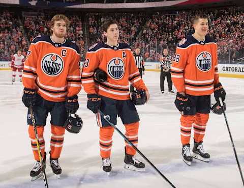 EDMONTON, AB – JANUARY 22: Connor McDavid #97, Ryan Nugent-Hopkins #93 and Jesse Puljujarvi #98 of the Edmonton Oilers sake against the Detroit Red Wings on January 22, 2019 at Rogers Place in Edmonton, Alberta, Canada. (Photo by Andy Devlin/NHLI via Getty Images)