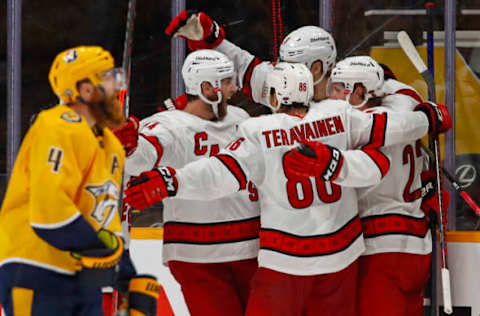 NASHVILLE, TENNESSEE – MAY 27: Teuvo Teravainen #86, Brock McGinn #23, Dougie Hamilton #19, and Jaccob Slavin #74 of the Carolina Hurricanes celebrate after scoring the game tying goal against the Nashville Predators during the third period in Game Six of the First Round of the 2021 Stanley Cup Playoffs at Bridgestone Arena on May 27, 2021 in Nashville, Tennessee. (Photo by Frederick Breedon/Getty Images)