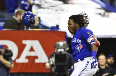 MONTREAL, QC – MARCH 27: Vladimir Guerrero Jr. #27 of the Toronto Blue Jays reacts after hitting a walk-off home run in the bottom of the ninth inning against the St. Louis Cardinals during the MLB preseason game at Olympic Stadium on March 27, 2018 in Montreal, Quebec, Canada. The Toronto Blue Jays defeated the St. Louis Cardinals 1-0. (Photo by Minas Panagiotakis/Getty Images)