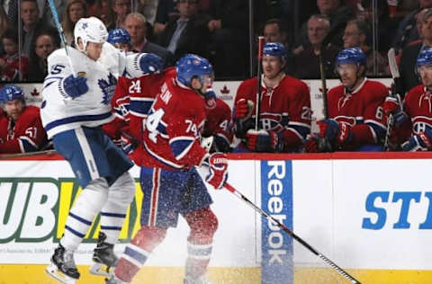 Nov 19, 2016; Montreal, Quebec, CAN; Toronto Maple Leafs left wing Matt Martin (15) is checked by Montreal Canadiens defenseman Alexei Emelin (74) during the third period at Bell Centre. Mandatory Credit: Jean-Yves Ahern-USA TODAY Sports