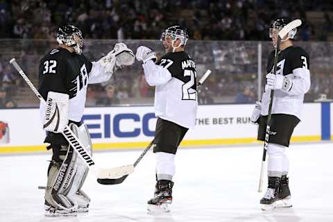 COLORADO SPRINGS, COLORADO – FEBRUARY 15: Jonathan Quick #32, Alec Martinez #27 and Matt Roy #3 of the Los Angeles Kings celebrate their win against the Colorado Avalanche during the 2020 NHL Stadium Series game at Falcon Stadium on February 15, 2020 in Colorado Springs, Colorado. (Photo by Matthew Stockman/Getty Images)