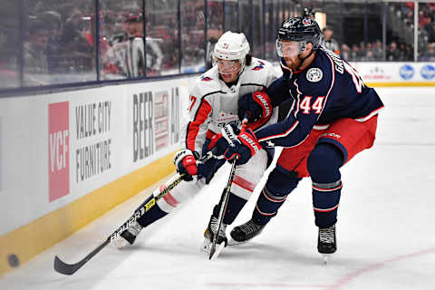 COLUMBUS, OH – DECEMBER 16: Vladislav Gavrikov #44 of the Columbus Blue Jackets defends against T.J. Oshie #77 of the Washington Capitals on December 16, 2019 at Nationwide Arena in Columbus, Ohio. (Photo by Jamie Sabau/NHLI via Getty Images)