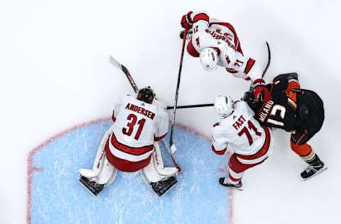 ANAHEIM, CALIFORNIA – NOVEMBER 18: Frederik Andersen #31, Nino Niederreiter #21, and Jesper Fast #71 of the Carolina Hurricanes defend against Sonny Milano #12 of the Anaheim Ducks during the third period of a game at Honda Center on November 18, 2021, in Anaheim, California. (Photo by Sean M. Haffey/Getty Images)