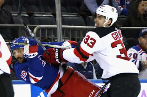 NEW YORK, NEW YORK – NOVEMBER 28: Vincent Trocheck #16 of the New York Rangers is checked by Ryan Graves #33 of the New Jersey Devils during the second period at Madison Square Garden on November 28, 2022, in New York City. (Photo by Bruce Bennett/Getty Images)