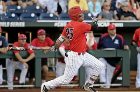 Jun 28, 2016; Omaha, NE, USA; Arizona Wildcats right fielder Zach Gibbons (23) hits a single during the first inning against the Coastal Carolina Chanticleers in game two of the College World Series championship series at TD Ameritrade Park. Mandatory Credit: Steven Branscombe-USA TODAY Sports