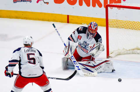 HARTFORD, CT – OCTOBER 18: Puck slides away from Hartford Wolfpack goaltender Igor Shesterkin (31) after he makes save as Hartford Wolfpack defenseman Vincent Loverde (26) closes in to clear puck during the Springfield Thunderbirds and Hartford Wolfpack AHL game on October 18, 2019, at XL Center in Hartford, CT. (Photo by John Crouch/Icon Sportswire via Getty Images)