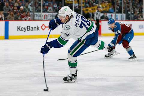 Mar 23, 2022; Denver, Colorado, USA; Vancouver Canucks left wing Tanner Pearson (70) attempts a shot in the third period against the Colorado Avalanche at Ball Arena. Mandatory Credit: Isaiah J. Downing-USA TODAY Sports