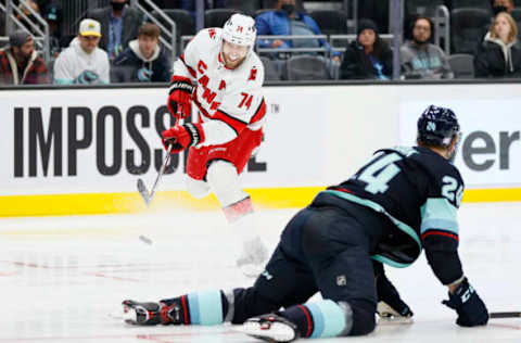 SEATTLE, WASHINGTON – NOVEMBER 24: Jaccob Slavin #74 of the Carolina Hurricanes shoots against Jamie Oleksiak #24 of the Seattle Kraken during the second period at Climate Pledge Arena on November 24, 2021, in Seattle, Washington. (Photo by Steph Chambers/Getty Images)