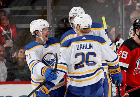 NEWARK, NEW JERSEY – APRIL 21: Rasmus Dahlin #26 of the Buffalo Sabres is congratulated by teammates Victor Olofsson #71 and Tage Thompson #72 during the second period against the New Jersey Devils at Prudential Center on April 21, 2022 in Newark, New Jersey. (Photo by Elsa/Getty Images)