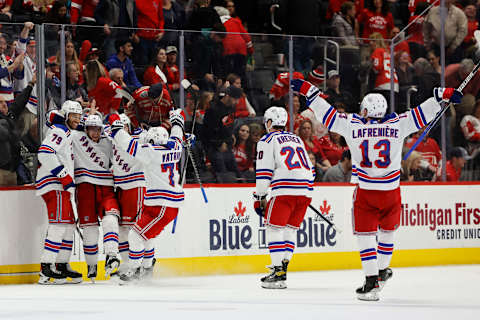 Mar 30, 2022; Detroit, Michigan, USA; New York Rangers center Andrew Copp (18) celebrates with teammates after scoring in overtime against the Detroit Red Wings at Little Caesars Arena. Mandatory Credit: Rick Osentoski-USA TODAY Sports