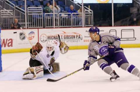 ORLANDO, FL – FEBRUARY 12: Eric Faille #27 of Orlando Solar Bears is stopped by Matt Ginn #90 of the Atlanta Gladiators on February 12, 2016 in Orlando, Florida. (Photo by Bruce Bennett/Getty Images)