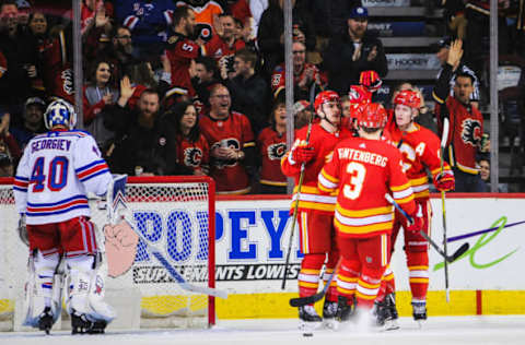 CALGARY, AB – MARCH 15: Matthew Tkachuk #19 (R) of the Calgary Flames celebrates with his teammates after scoring against Alexandar Georgiev #40 of the New York Rangers during an NHL game at Scotiabank Saddledome on March 15, 2019 in Calgary, Alberta, Canada. (Photo by Derek Leung/Getty Images)