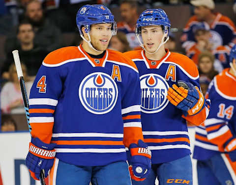 Nov 20, 2015; Edmonton, Alberta, CAN; Edmonton Oilers forward Taylor Hall (4) and forward Ryan Nugent-Hopkins (93) talk between whistles against the New Jersey Devils at Rexall Place. Mandatory Credit: Perry Nelson-USA TODAY Sports