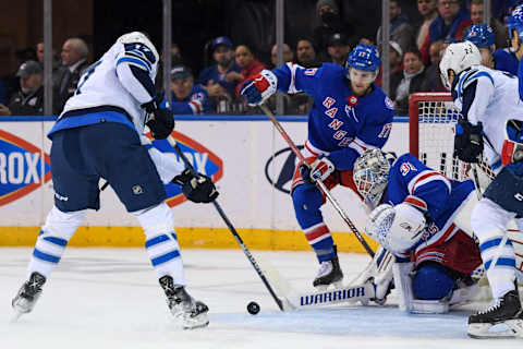 Apr 19, 2022; New York, New York, USA; Winnipeg Jets center Adam Lowry (17) attempts to shoot a loose puck in front of New York Rangers goaltender Igor Shesterkin (31) during the second period at Madison Square Garden. Mandatory Credit: Dennis Schneidler-USA TODAY Sports