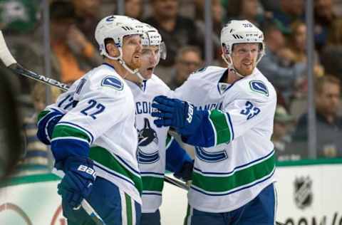 Oct 29, 2015; Dallas, TX, USA; Vancouver Canucks left wing Daniel Sedin (22) and right wing Radim Vrbata (17) and center Henrik Sedin (33) celebrate the goal by Vrbata against the Dallas Stars during the third period at the American Airlines Center. The Stars defeat the Canucks 4-3 in overtime. Mandatory Credit: Jerome Miron-USA TODAY Sports