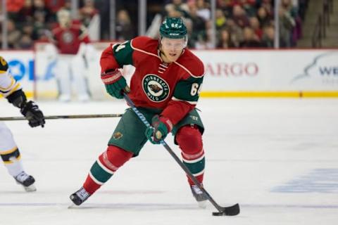 Feb 13, 2016; Saint Paul, MN, USA; Minnesota Wild forward Mikael Granlund (64) skates with the puck in the second period against the Boston Bruins at Xcel Energy Center. Mandatory Credit: Brad Rempel-USA TODAY Sports