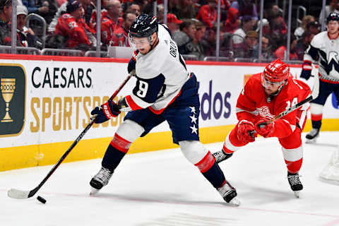 Feb 21, 2023; Washington, District of Columbia, USA; Washington Capitals defenseman Dmitry Orlov (9) clears the puck as Detroit Red Wings center Robby Fabbri (14) looks on during the second period at Capital One Arena. Mandatory Credit: Brad Mills-USA TODAY Sports