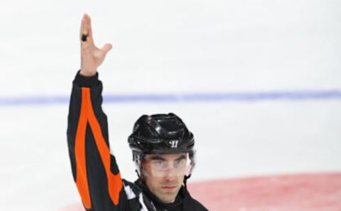 TORONTO, ON – FEBRUARY 22: Referee Michael Markovic #47 signals a delayed penalty during play between the Calgary Flames and the Toronto Maple Leafs . (Photo by Claus Andersen/Getty Images)