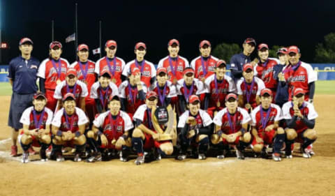 Jul 10, 2016; Oklahoma City, OK, USA; Team Japan poses for a photos with the World Cup of Softball Championship Trophy after defeating Team USA at ASA Hall of Fame Complex. Japan won 2-1. Mandatory Credit: Alonzo Adams-USA TODAY Sports