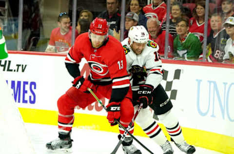 RALEIGH, NC – OCTOBER 26: Warren Foegele #13 of the Carolina Hurricanes battles for a puck behind the net with Zack Smith #15 of the Chicago Blackhawks during an NHL game on October 26, 2019 at PNC Arena in Raleigh North Carolina. (Photo by Gregg Forwerck/NHLI via Getty Images)