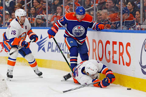 Nov 13, 2023; Edmonton, Alberta, CAN; Edmonton Oilers forward James Hamblin (57) knocks down New York Islanders defensemen Noah Dobson (8) while battling for a loose puck during the first period at Rogers Place. Mandatory Credit: Perry Nelson-USA TODAY Sports