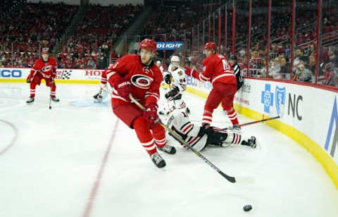 Jan 26, 2016; Raleigh, NC, USA; Carolina Hurricanes defensemen Noah Hanifin (5) skates with the puck against the Chicago Blackhawks at PNC Arena. The Carolina Hurricanes defeated the Chicago Blackhawks 5-0. Mandatory Credit: James Guillory-USA TODAY Sports