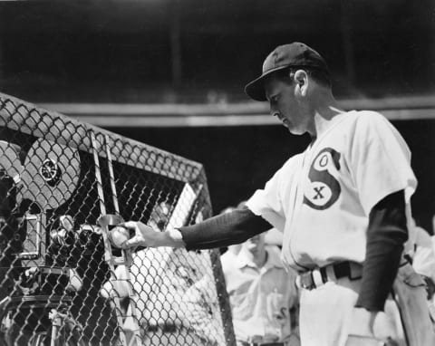 CHICAGO – 1940. Ted Lyons, pitcher for the Chicago White Sox, examines a new pitching machine before a game at Comiskey Park in Chicago. (Photo by Mark Rucker/Transcendental Graphics, Getty Images)