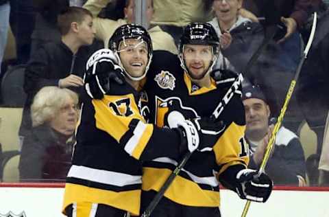 NHL Power Rankings: Pittsburgh Penguins right wing Bryan Rust (17) celebrates with center Nick Bonino (13) after scoring a goal to complete a hat trick against the Ottawa Senators during the third period at the PPG PAINTS Arena. The Penguins won 8-5. Mandatory Credit: Charles LeClaire-USA TODAY Sports