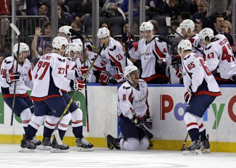 Jan 9, 2016; New York, NY, USA; Washington Capitals left wing Alex Ovechkin (8) celebrates with teammates after scoring the game winning goal against the New York Rangers during overtime of an NHL hockey game at Madison Square Garden. The Capitals defeated the Rangers 4-3 in overtime. Mandatory Credit: Adam Hunger-USA TODAY Sports