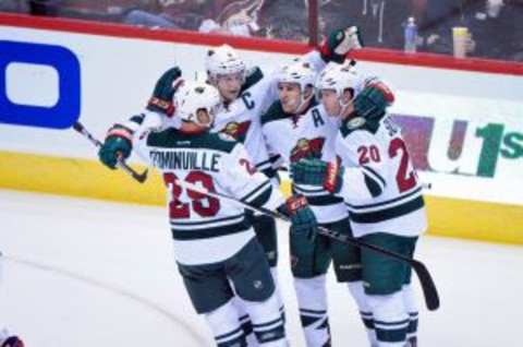 Oct 15, 2015; Glendale, AZ, USA; Minnesota Wild left wing Zach Parise (11) celebrates with right wing Jason Pominville (29), defenseman Ryan Suter (20) and center Mikko Koivu (9) after scoring a power play goal in thefirst period against the Arizona Coyotes at Gila River Arena. Mandatory Credit: Matt Kartozian-USA TODAY Sports