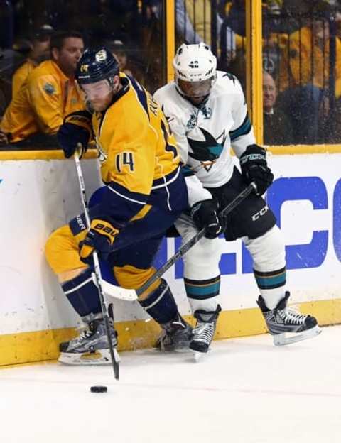 May 5, 2016; Nashville, TN, USA; Nashville Predators defenseman Mattias Ekholm (14) skates against San Jose Sharks right wing Joel Ward (42) for the loose puck during the overtime period in game four of the second round of the 2016 Stanley Cup Playoffs at Bridgestone Arena. Mandatory Credit: Aaron Doster-USA TODAY Sports