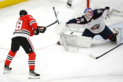 Dec 23, 2022; Chicago, Illinois, USA; Columbus Blue Jackets goaltender Joonas Korpisalo (70) defends against Chicago Blackhawks right wing Patrick Kane (88) during the third period at the United Center. Mandatory Credit: Matt Marton-USA TODAY Sports